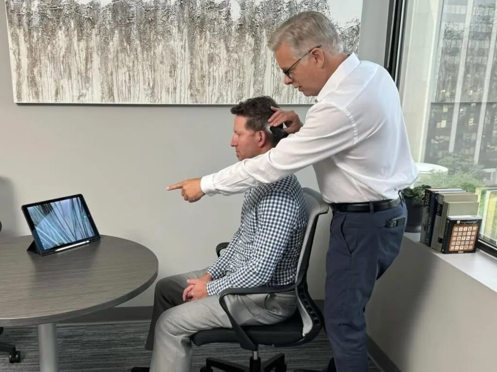 RESTORE physician reviewing a scalp analysis with a patient