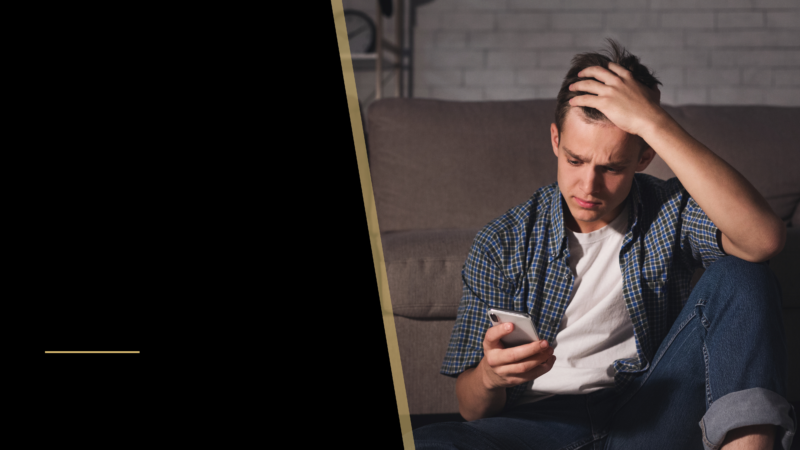 Hair Transplant at 24 years old 12 a young man looking at his phone