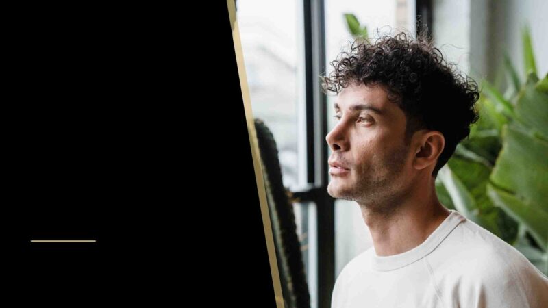 A man looking through a window