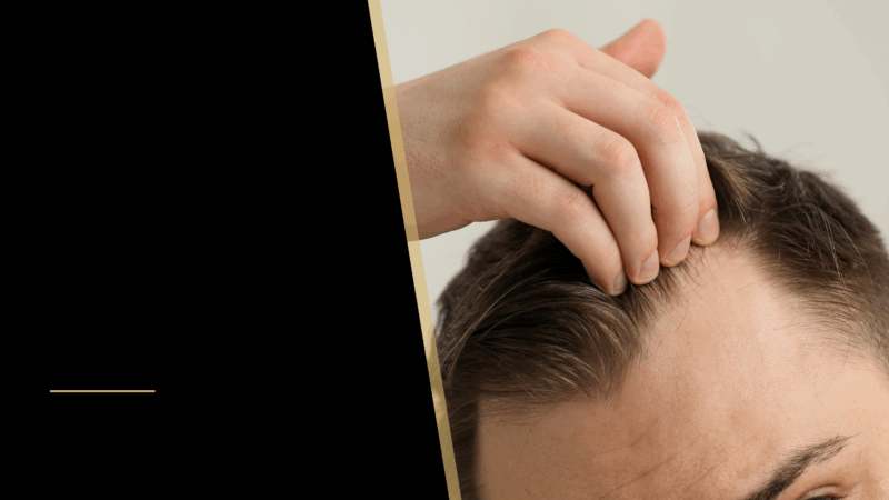A man touching his hair
